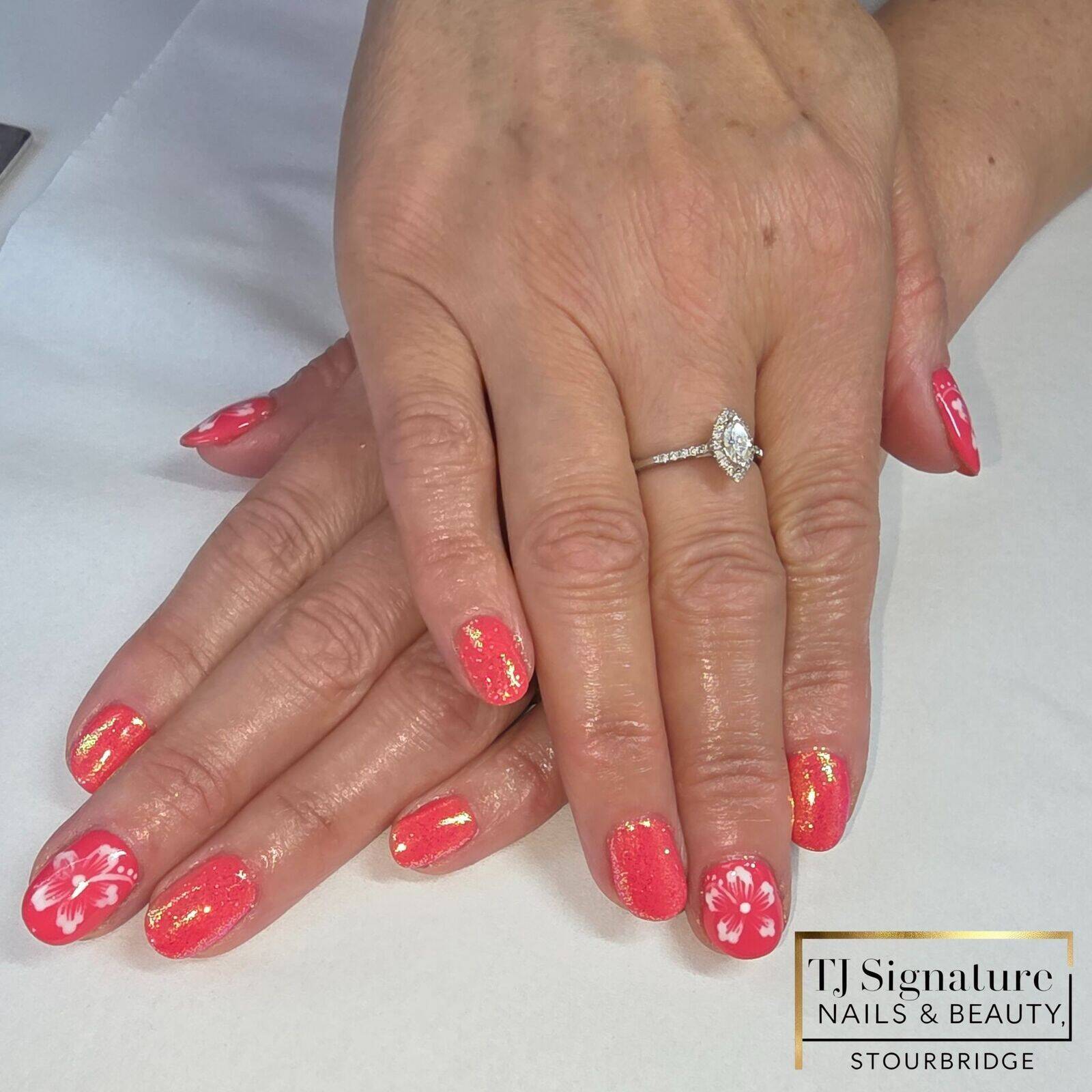 Coral shimmer with hand-painted white hibiscus flowers – bold, tropical and eye-catching.