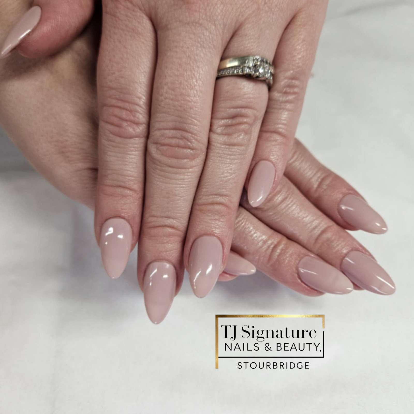 These nails have a nude glossy finish in a chic almond shape, giving a clean and elegant look that works for any occasion