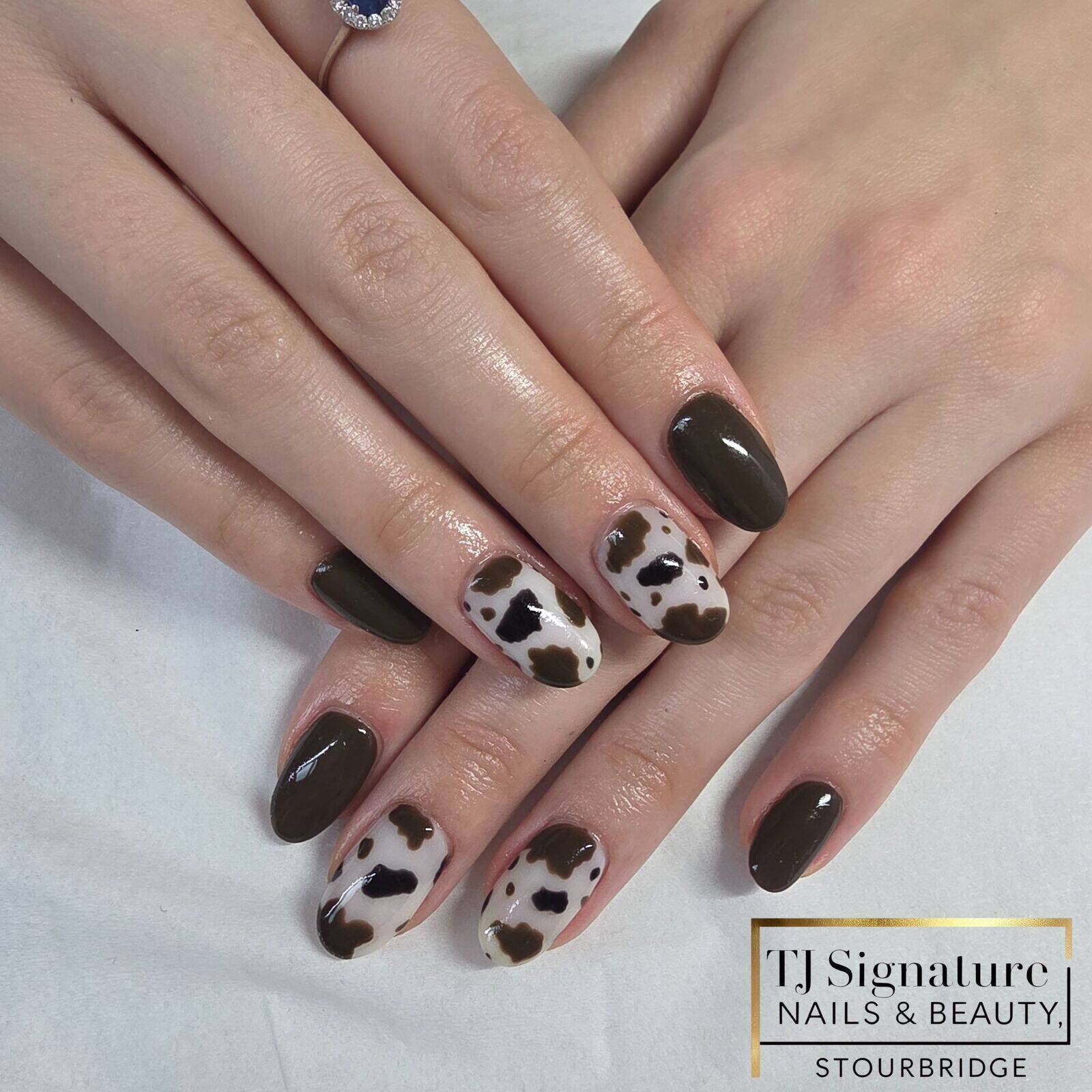 Glossy BIAB nails featuring multiple cow print accent nails. A balanced design that feels modern yet wearable, offering strength, durability and a polished finish.