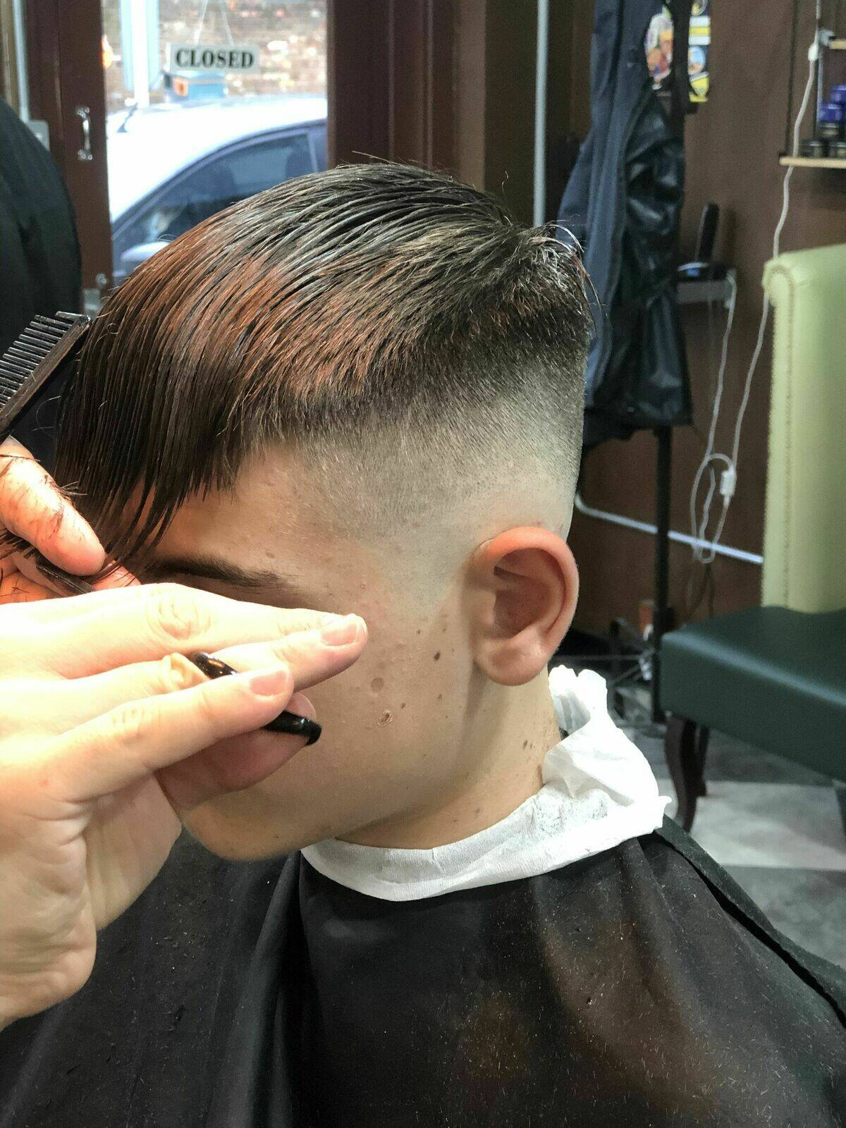 Our barber in action creating an expert skin fade and styling as requested.