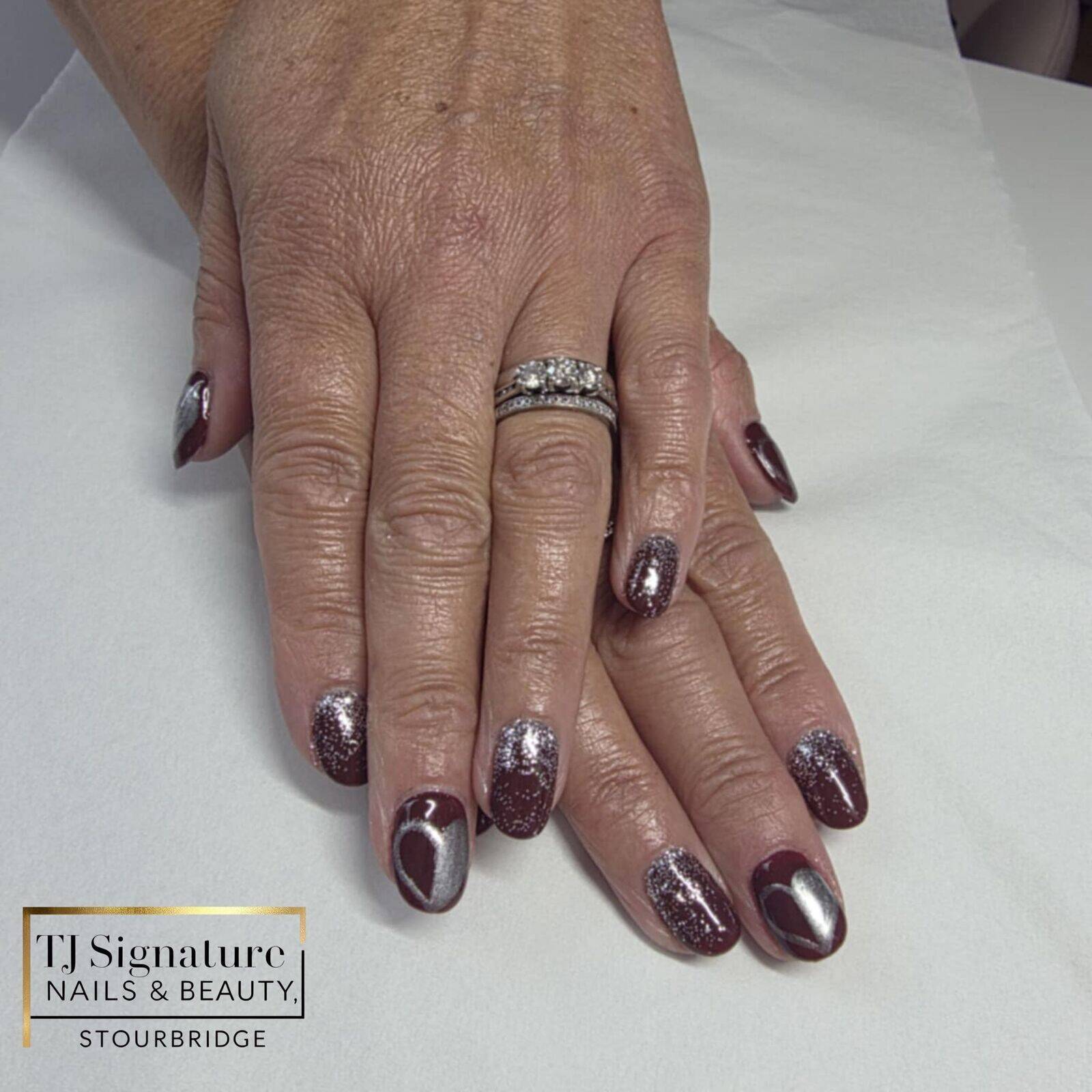 Deep wine nails with silver chrome hearts — elegant, romantic, and perfect for the season. ❤️✨