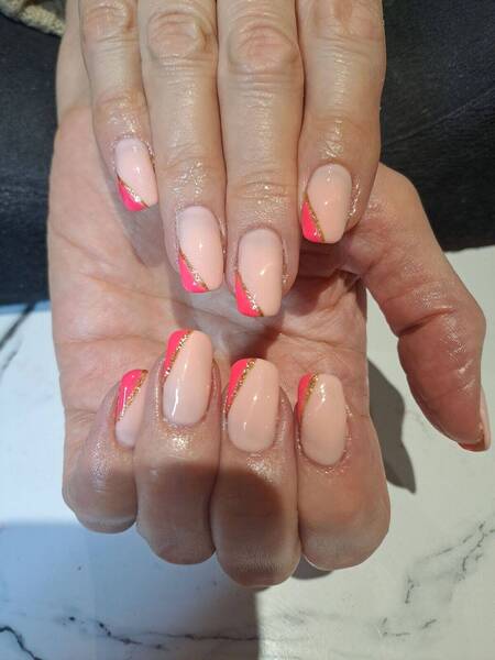 Half a pink french tip with glitter on a nude biab base