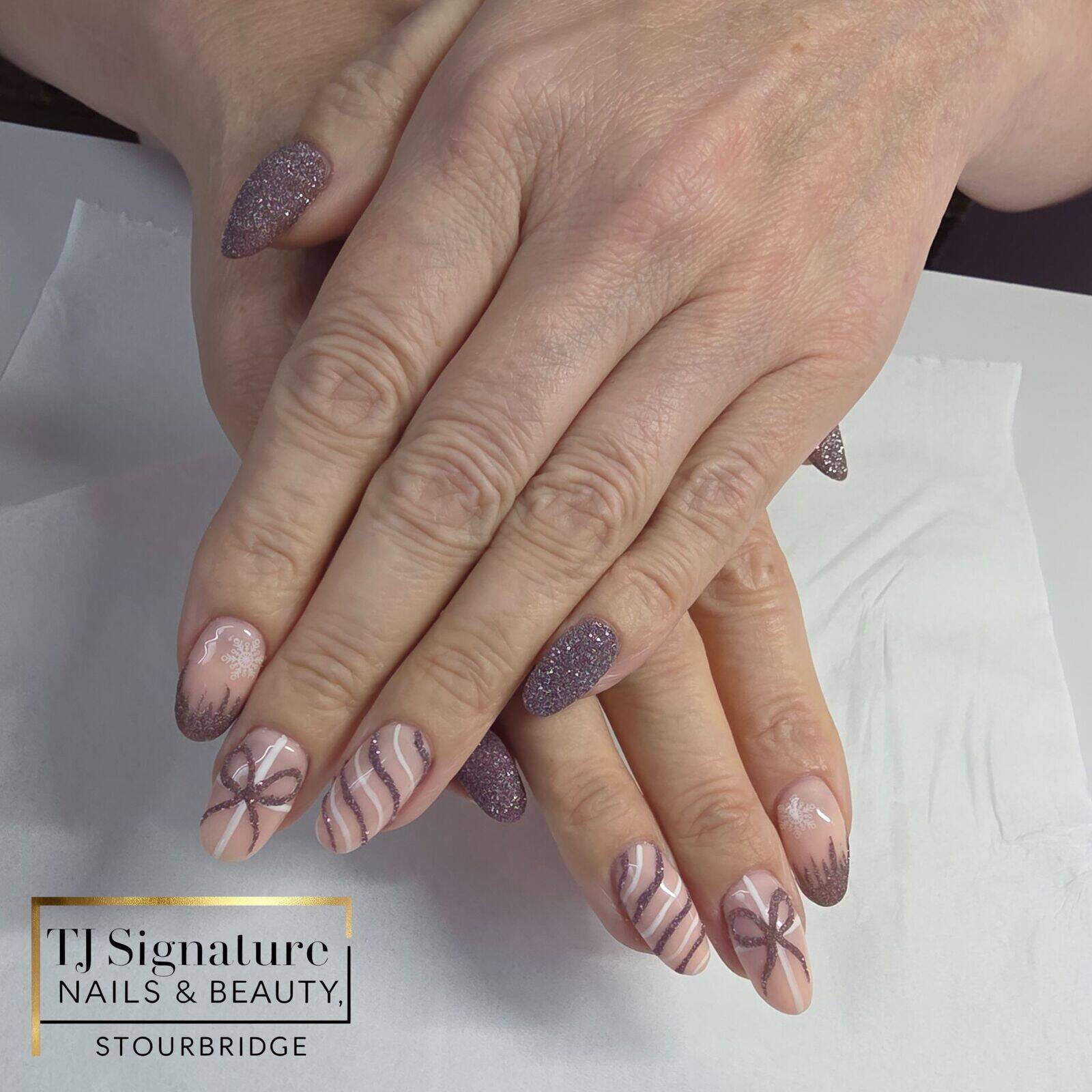 BIAB nails with custom mixed reflective glitter for a colour-shifting sparkle, finished with full glitter accents, delicate swirls, a bow detail, and subtle snowflake and icicle touches. ✨❄️