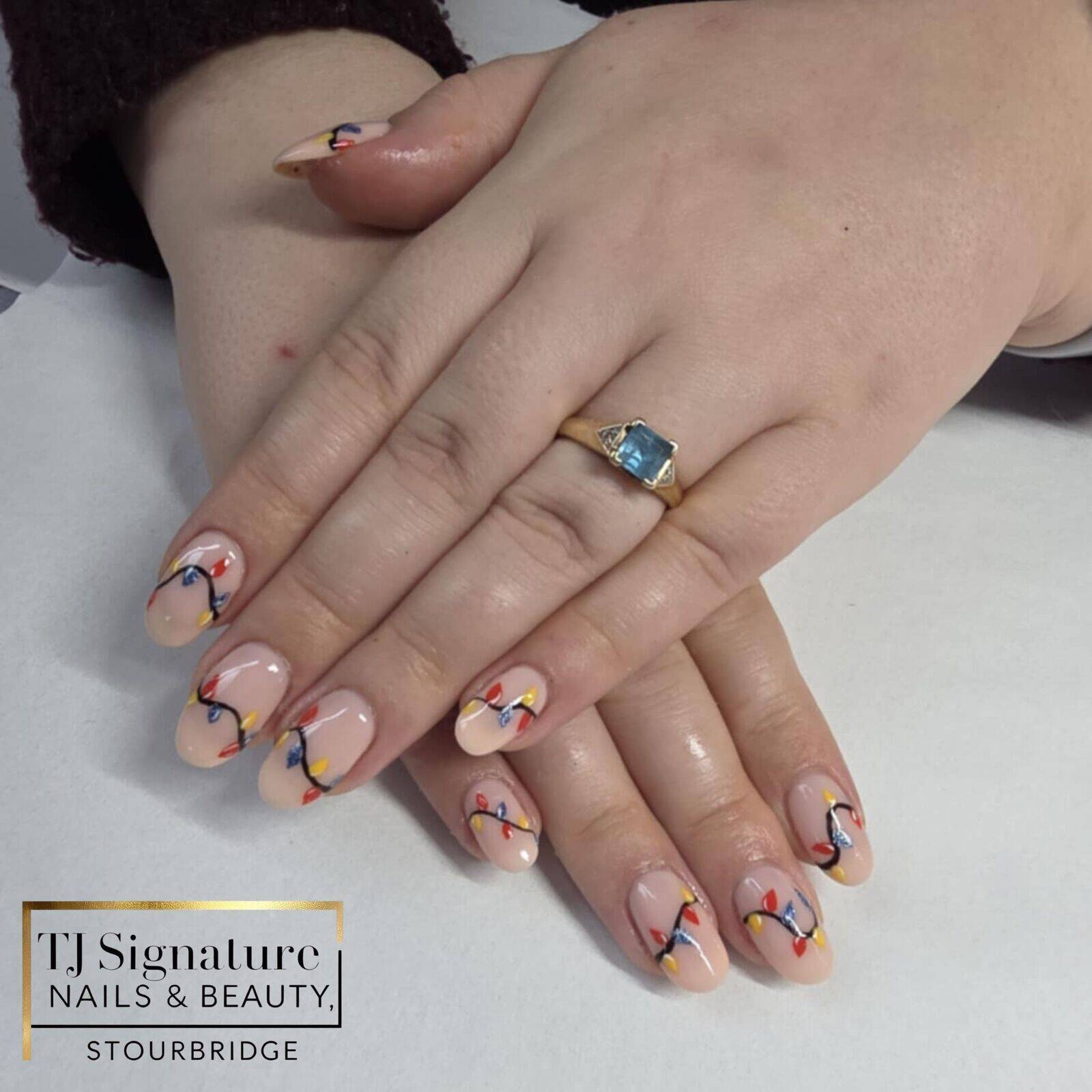 Stranger Things inspired with a festive twist — a soft nude base finished with colourful fairy-light details for a fun yet wearable Christmas design.