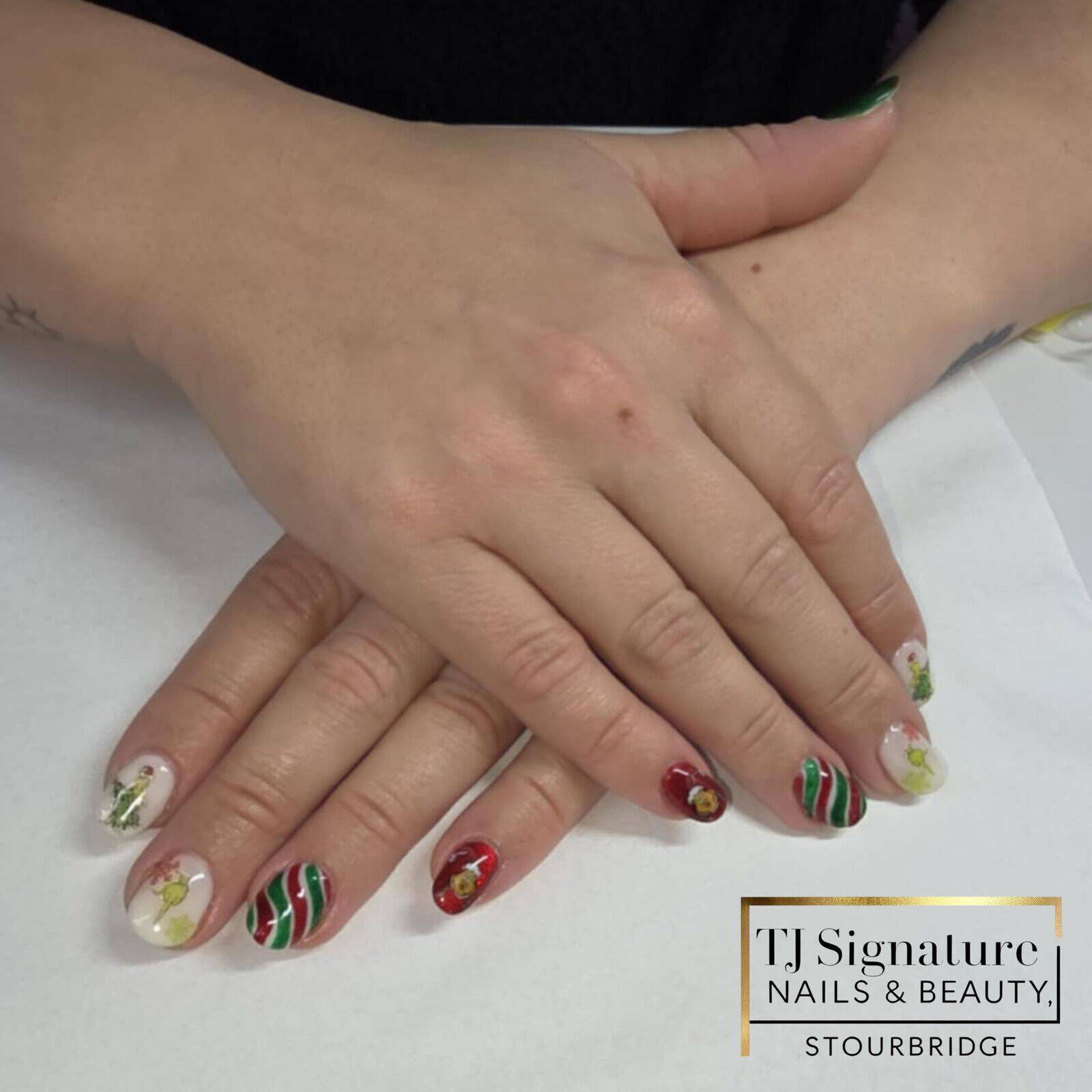 Grinch-inspired festive nails with classic Christmas reds and greens, playful swirls and fun seasonal motifs — full of personality and totally unique for each client. 🎄💚