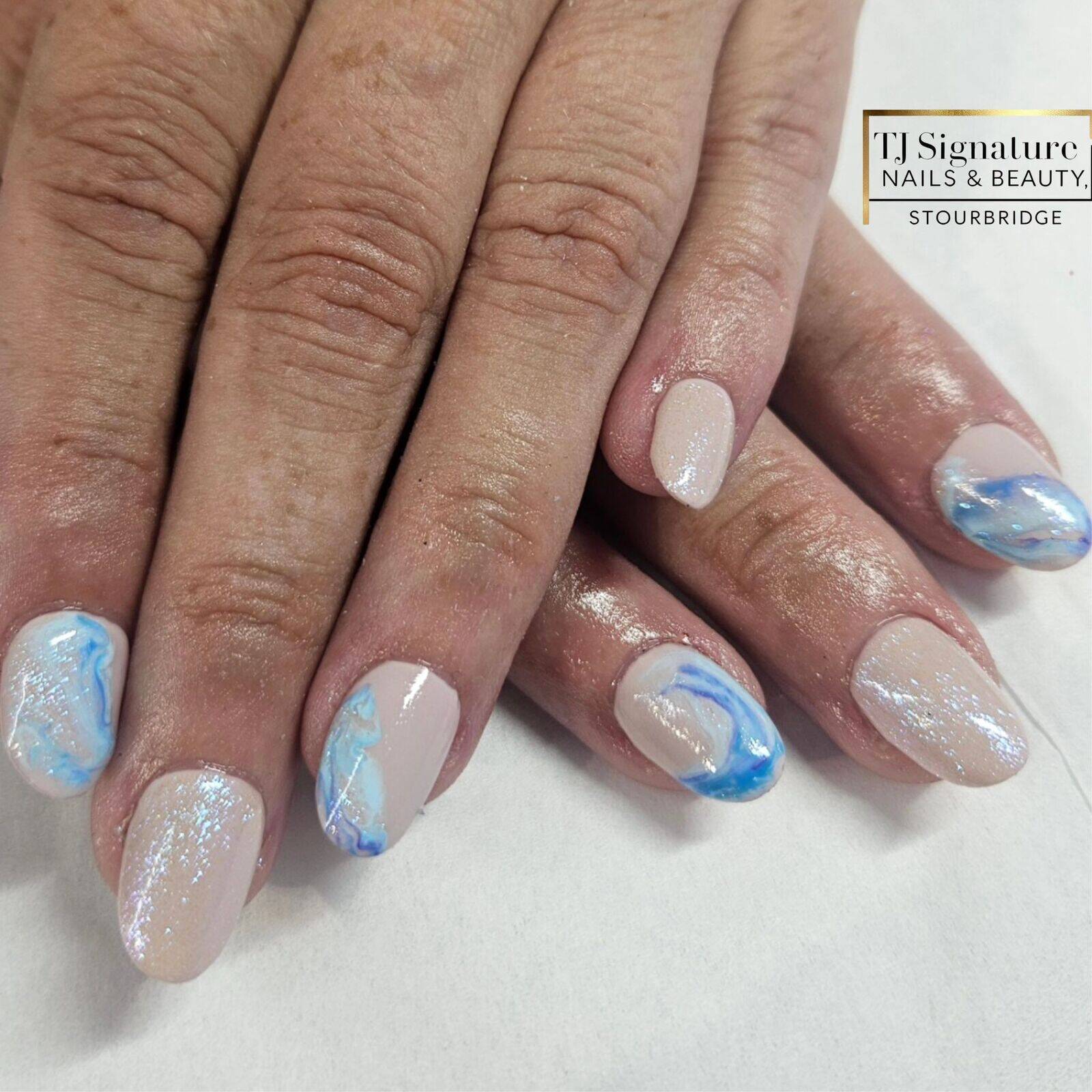 Gel bond extensions with a blue marble over Gelish 'i feel flowerful'