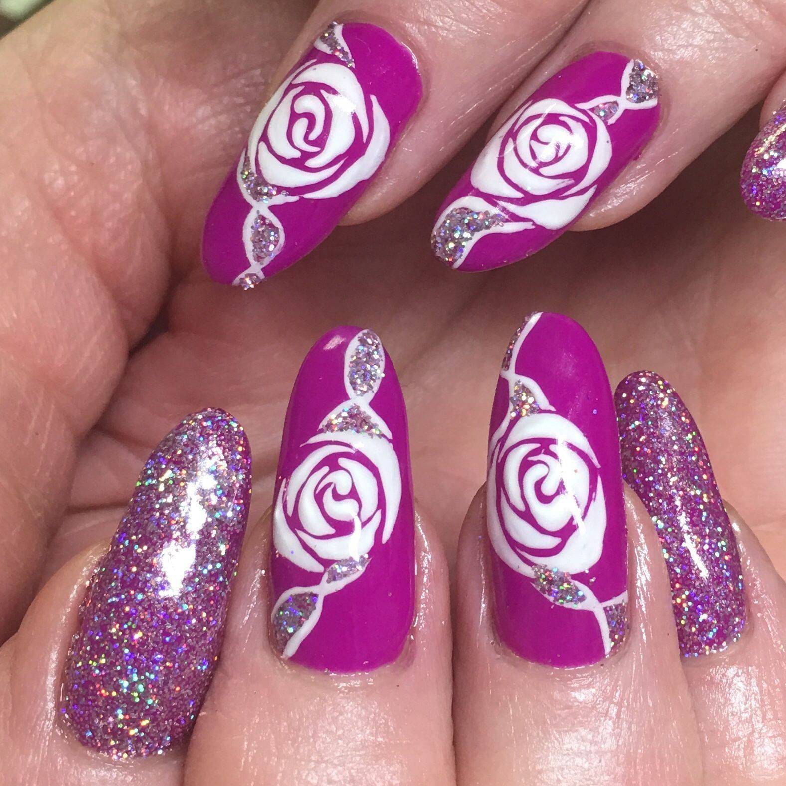 Bold and beautiful. Natural nails with a @Gelish #polygel overlay with #youglareiglow glitter and white rose details. Who’s on love?