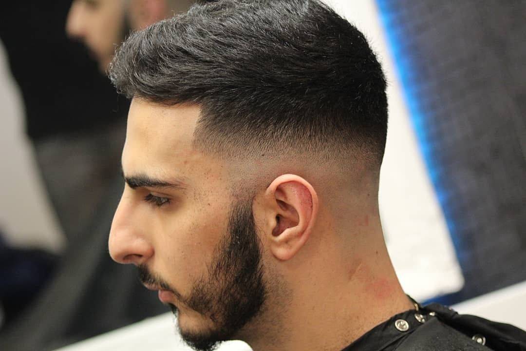 Clean fade with a natural beard ✌ by @levi_bramley