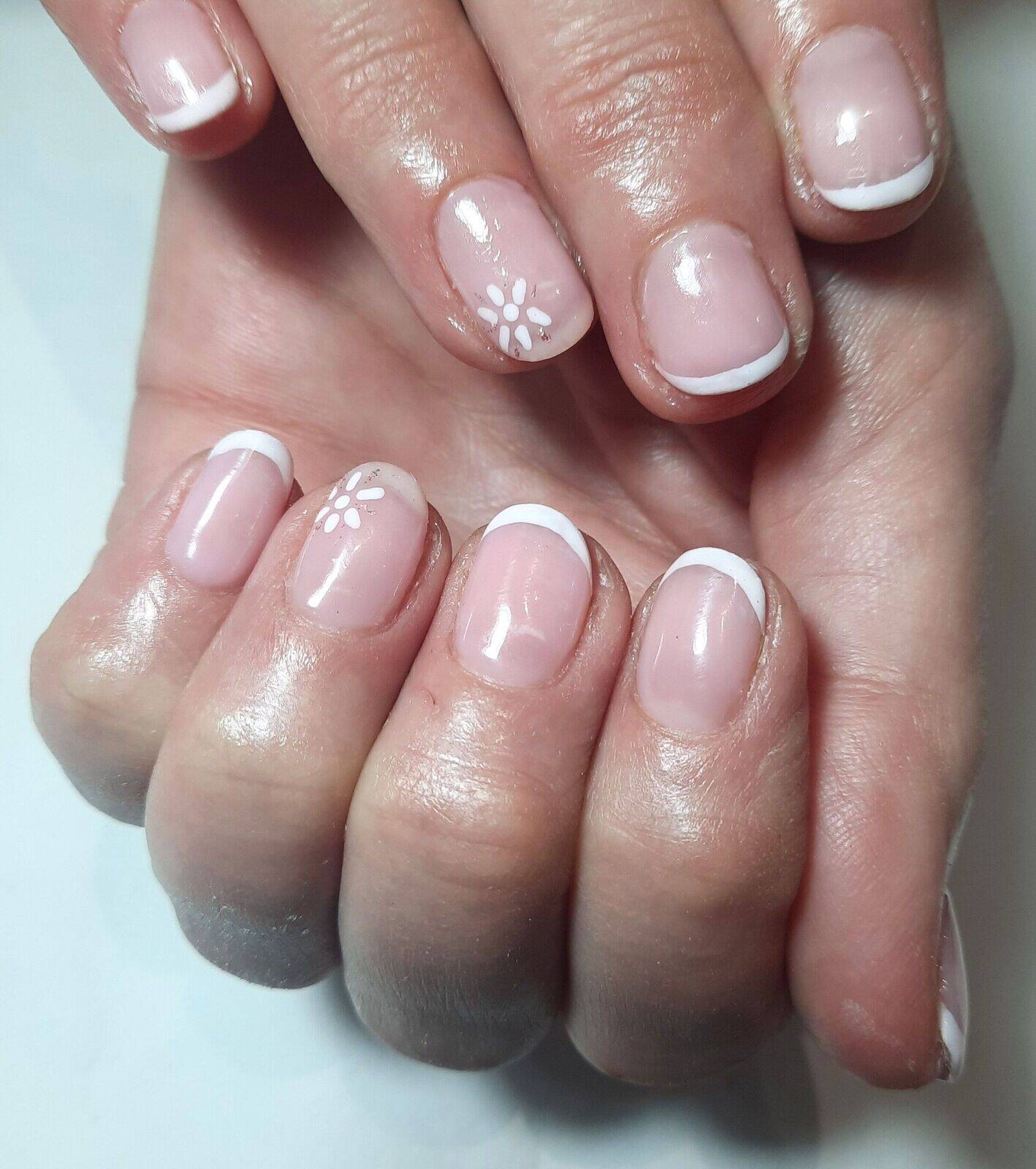Simple white french tip with daisy design