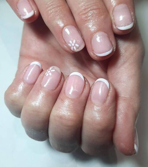 Simple white french tip with daisy design