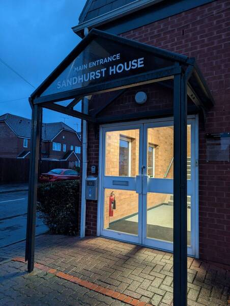 Main entrance on the left-handside of building. Please walk upstairs.