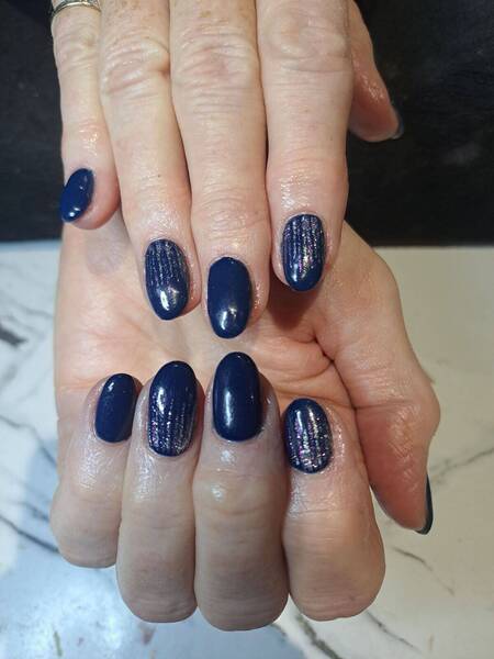 Navy gel polish with a rainbow glitter rain fall