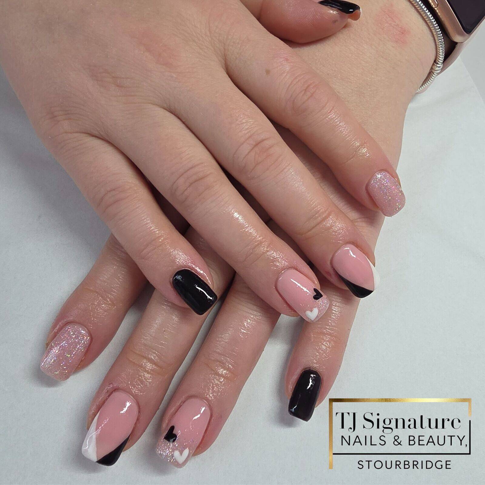 A soft pink base paired with bold black accents and delicate hearts, finished with a touch of sparkle — a cute and modern mixed design.