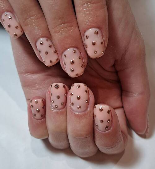 A nude biab base with copper polka dots