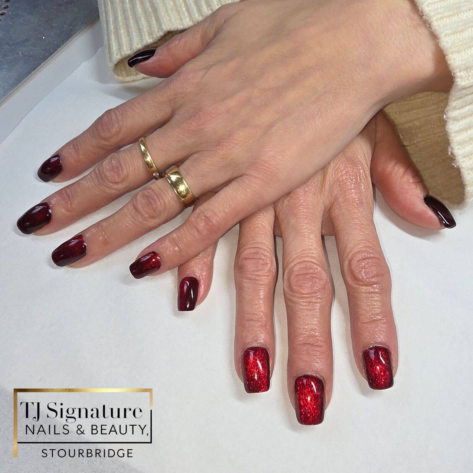 A black-red cat-eye gel manicure with a light-reactive finish that shifts between deep black and rich red tones. Glossy, elegant and beautifully unique in every light.