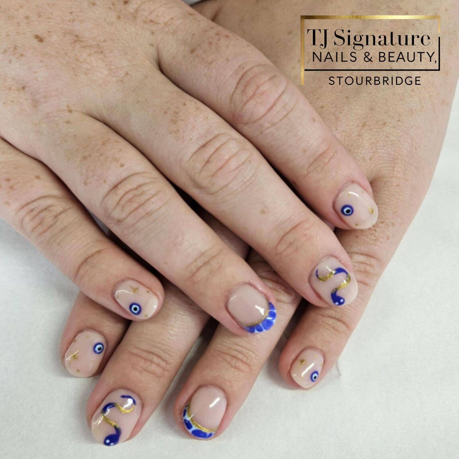 “Mamma Mia” inspired — a soft nude base with hand-painted cobalt blue evil eyes, shimmering gold accents, and a bold blue-and-gold snake for that perfect Mediterranean summer vibe.