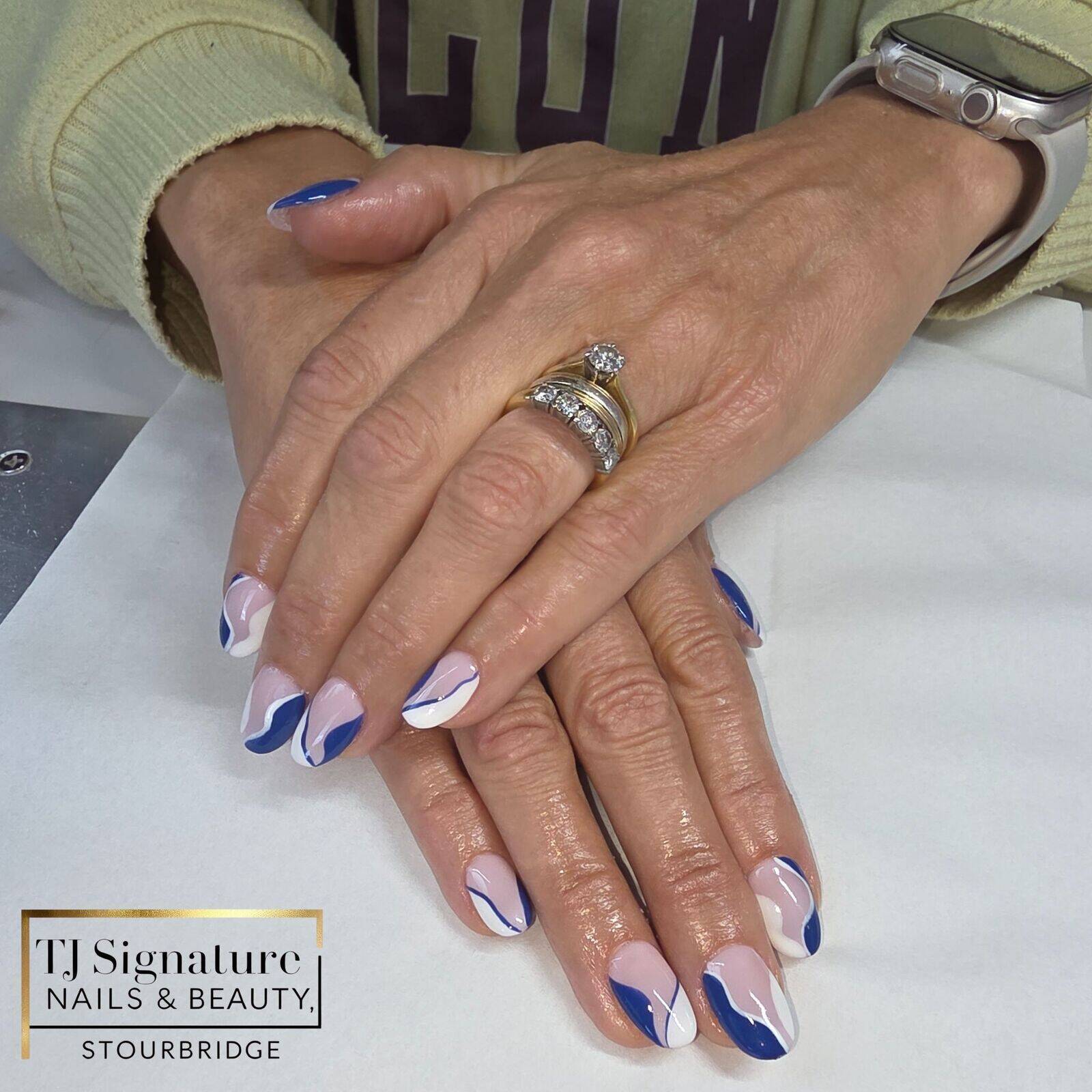 Gel bond extensions finished with pink, white and blue swirls – a stylish, modern look that’s elegant yet eye-catching.