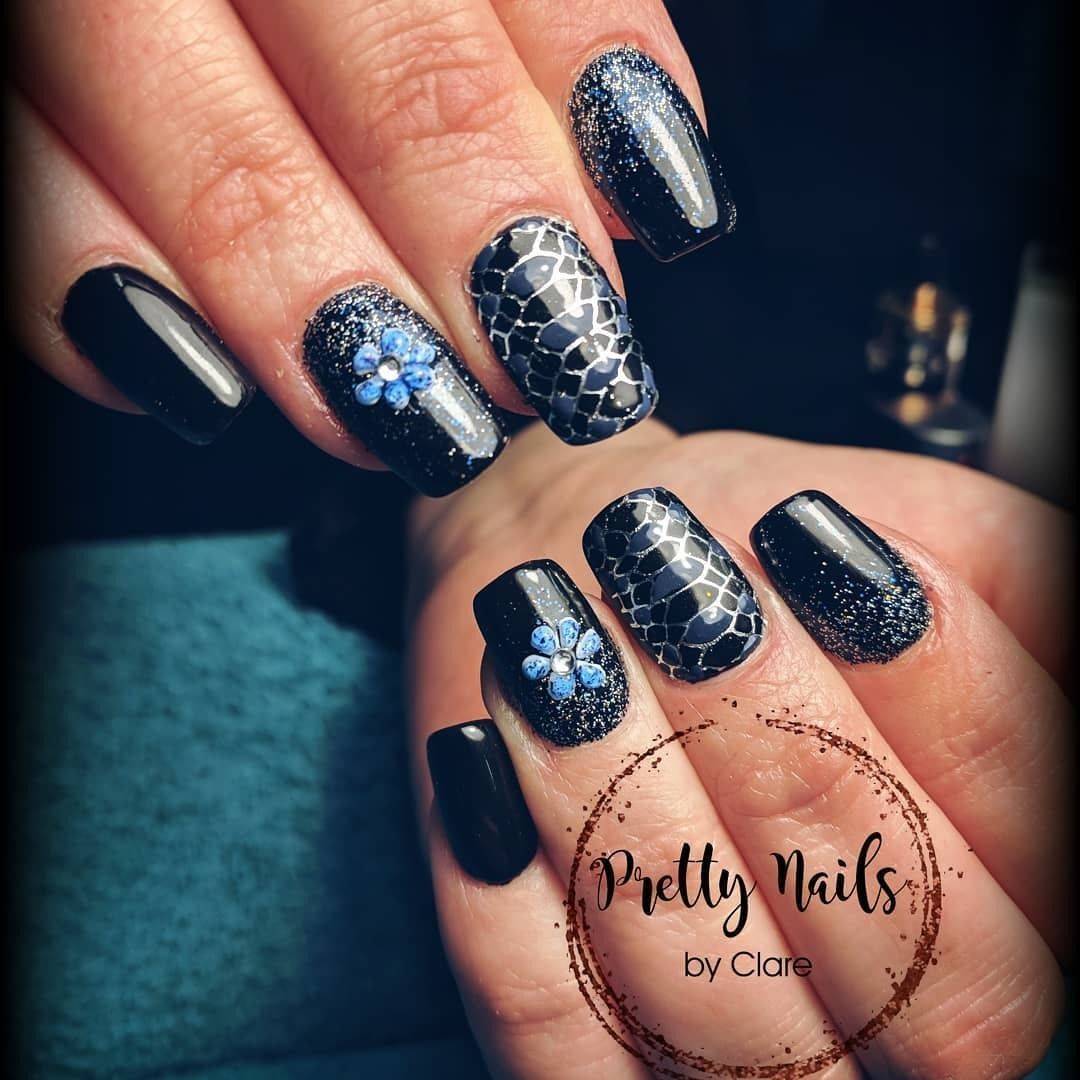 Another gorgeous black set!  #black #glitter #flower #snakeprint #prettynailsbyclare #naillandstudioandtraining
